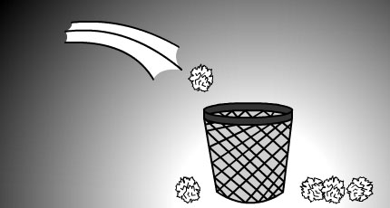 This image shows a crumpled ball of paper being thrown into a waste basket. There are several balls of paper scattered on the ground from previous failed attempts.